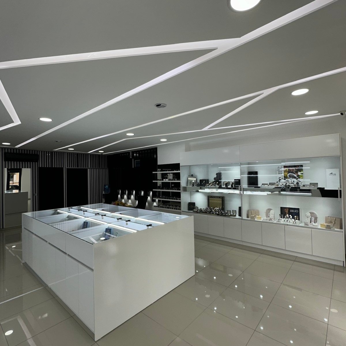 Modern minimalist retail showroom with white central display counter